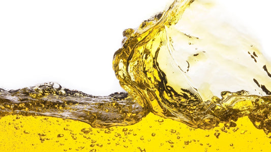 Oil circulating inside the compression chamber of an oil-lubricated air compressor during operation.
